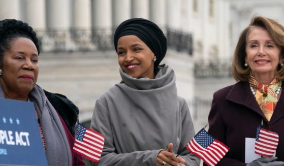 Reps. Sheila Jackson Lee, left, Ilhan Omar, center, and then-House Speaker Nancy Pelosi, right, celebrate 100 days of Democrats taking a majority in the house outside the Capitol in Washington, D.C., on March 8, 2019.