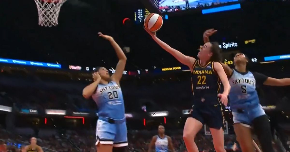 Angel Reese of the Chicago Sky fouls Caitlin Clark of the Indiana Fever.