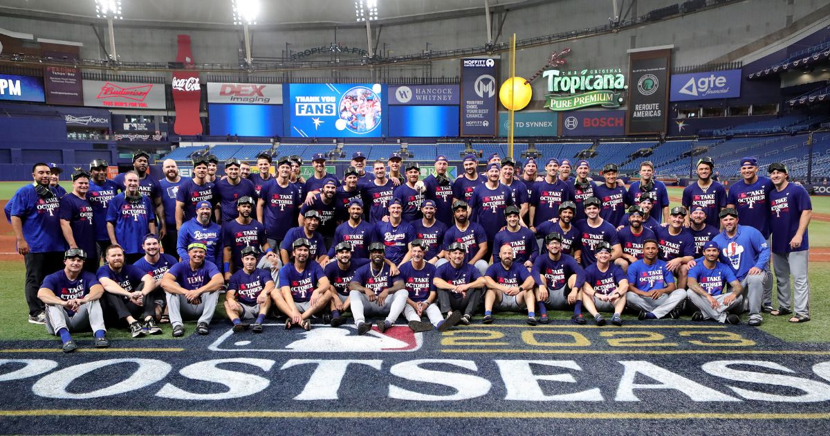 The Texas Rangers pose for a team photo after defeating the Tampa Bay Rays 7-1in Game Two of the Wild Card Series at Tropicana Field in St. Petersburg, Florida, on Oct. 4, 2023.