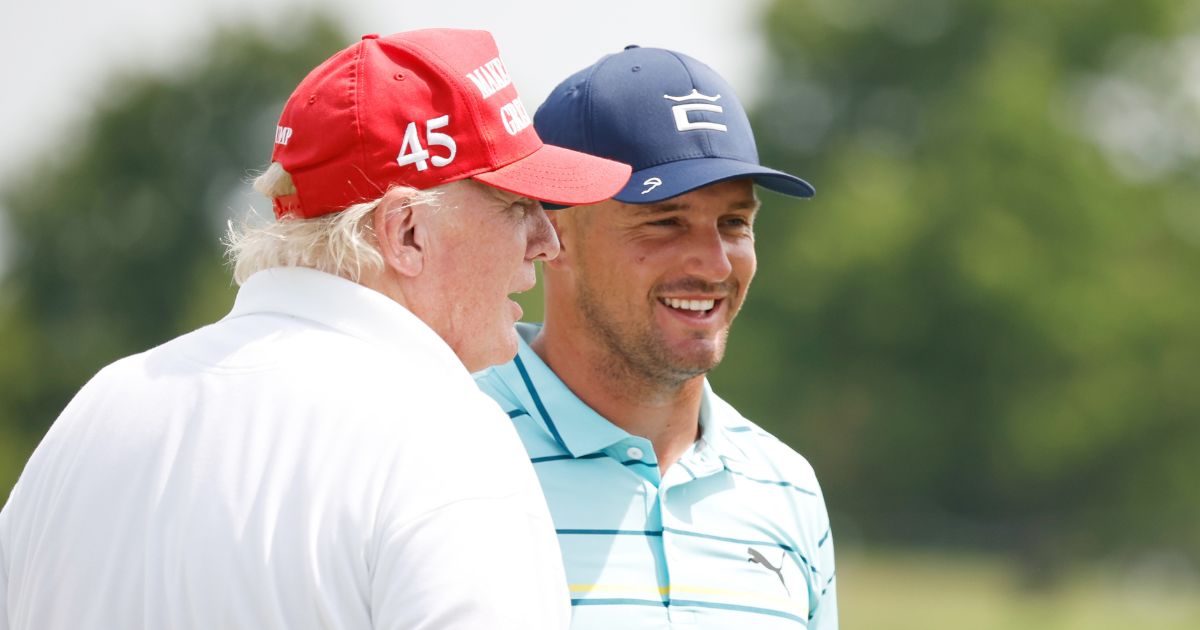 Former President Donald Trump and Bryson DeChambeau talk on the 18th green during the pro-am prior to the LIV Golf Invitational - Bedminster at Trump National Golf Club Bedminster in Bedminster, New Jersey, on on July 28, 2022.
