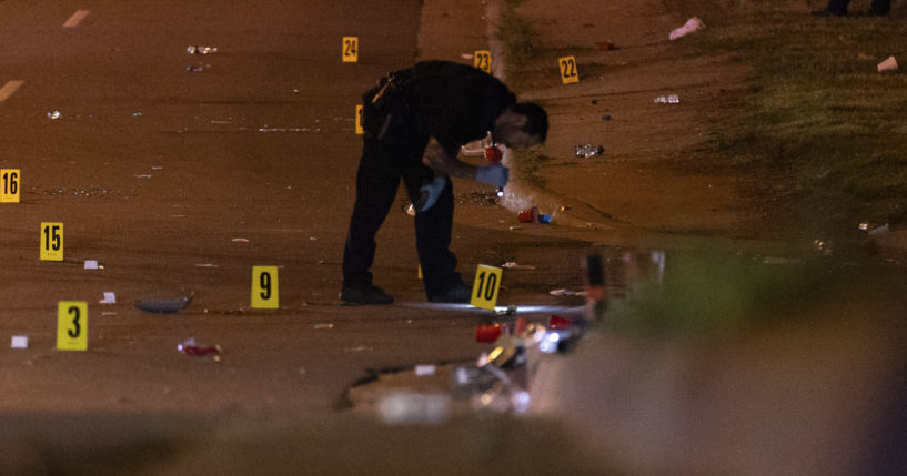 An officer of the Akron Police Department investigating a shooting that happened overnight in Akron, Ohio, on Sunday.