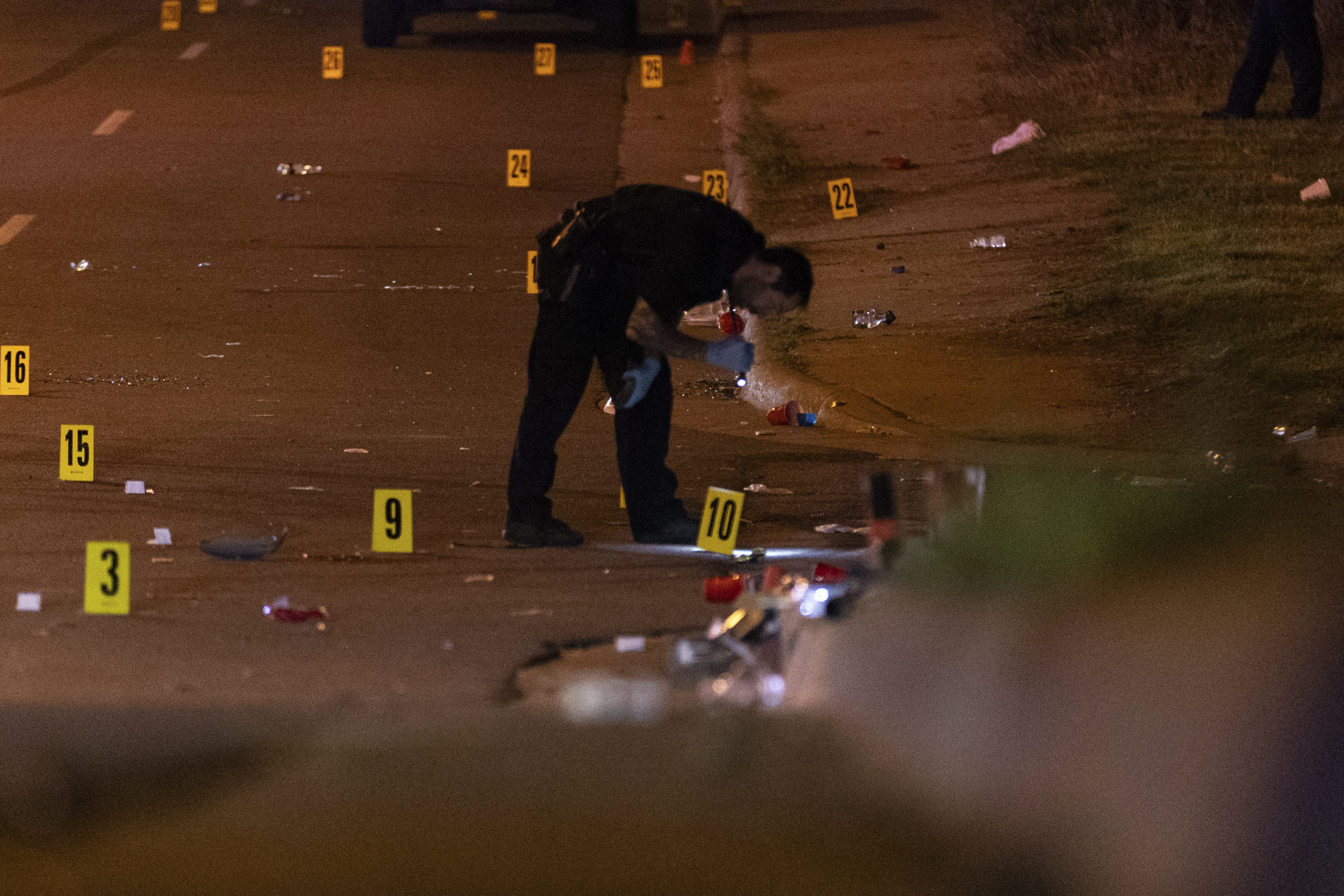 An officer of the Akron Police Department investigating a shooting that happened overnight in Akron, Ohio, on Sunday.