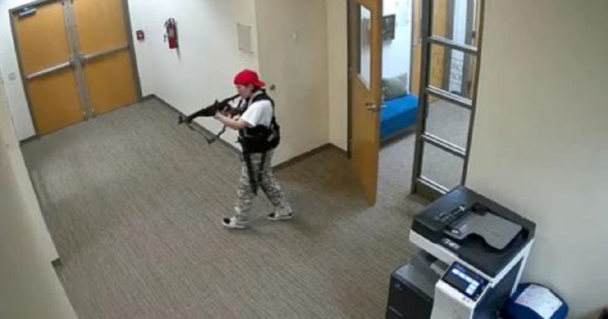 Audrey Hale, the killer at The Covenant School in Nasvhville in March 2023, stalks the school's halls with a rifle in a surveillance photo.