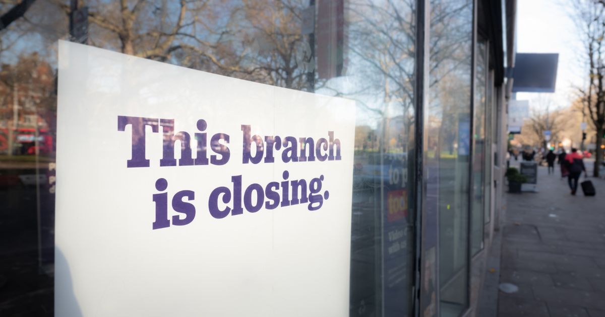 A stock photo shows a sign in a window that reads, "This branch is closing."