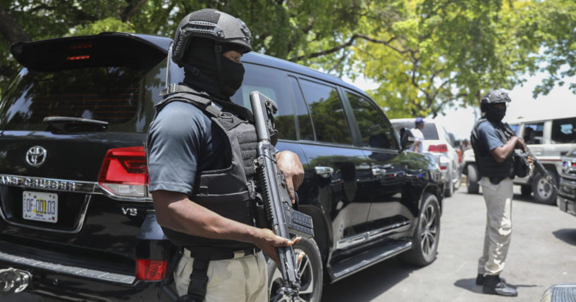 Security guards stand guard as Haiti's Prime Minister Garry Conille leaves after attending the inauguration of the nation's new cabinet in Port-au-Prince, Haiti, Wednesday, June 12, 2024.