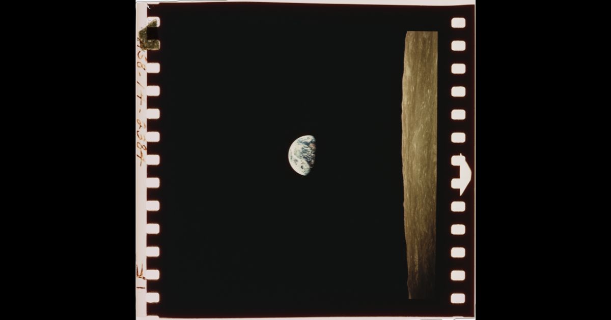 A view of the Earth beyond the lunar horizon, taken from the Apollo 8 spacecraft while in orbit around the Moon, by crewmember Bill Anders, 24th December 1968.