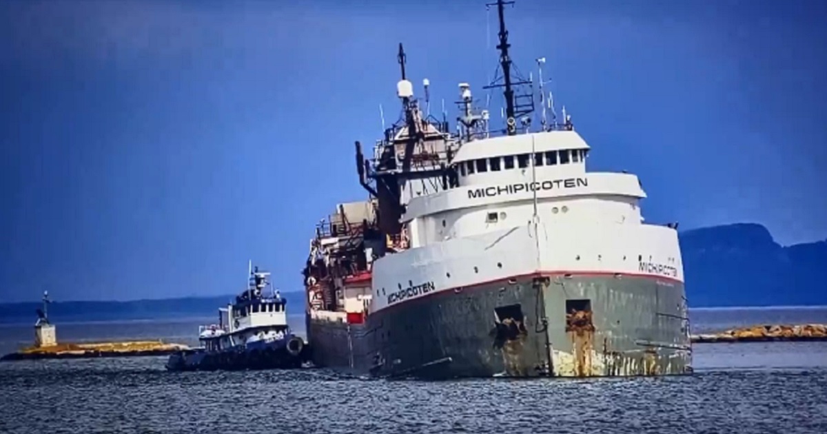 The freighter Michipoceten visibling listing as a tug boat assists it into Thunder Bay harbor in Ontario on Saturday.