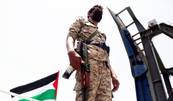 A fighter of the Houthi group stands on the Galaxy Leader Vessel as he guards it, on the Red Sea coast off Hudaydah, on May 12, 2024, in the Red Sea, Yemen.