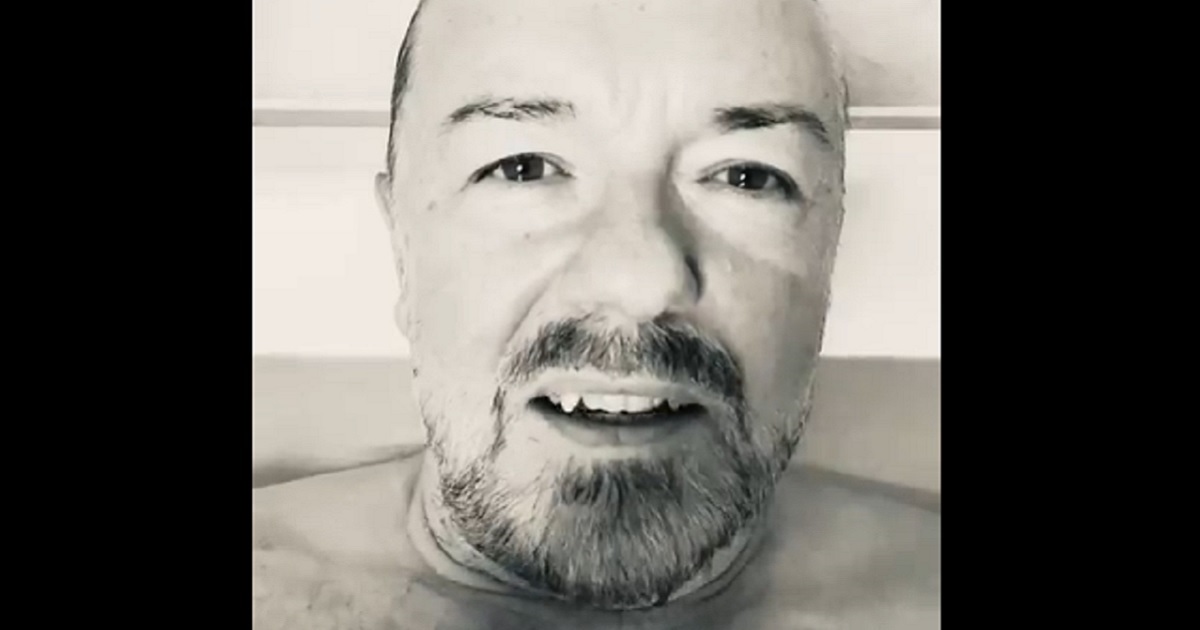 Comedian Ricky Gervais is pictured with his head and neck above the waterline in a bathtub.