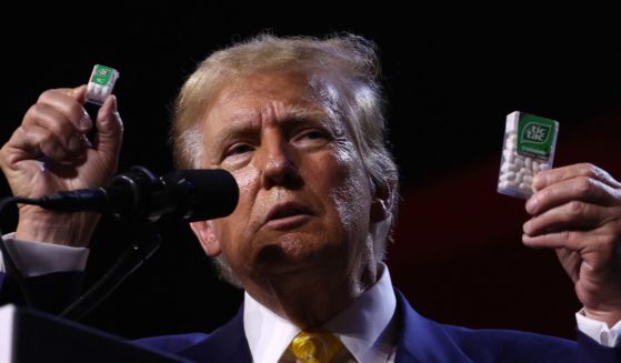 Former U.S. President Donald Trump holds up Tic Tacs as he speaks during a Turning Point PAC town hall at Dream City Church on June 6, 2024 in Phoenix, Arizona.