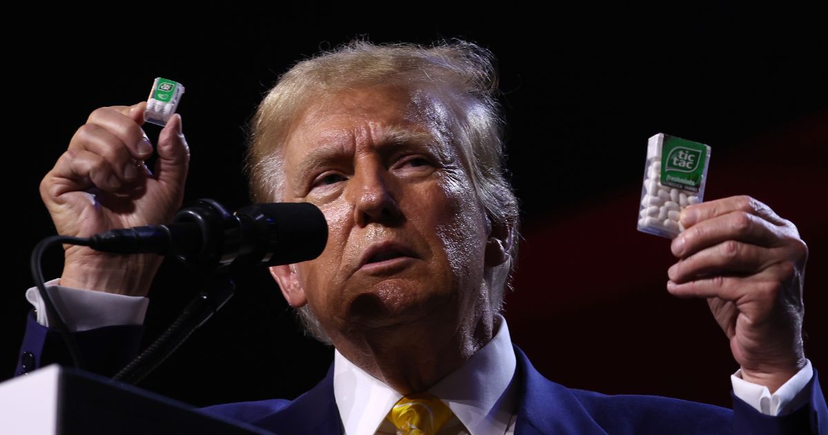 Former U.S. President Donald Trump holds up Tic Tacs as he speaks during a Turning Point PAC town hall at Dream City Church on June 6, 2024 in Phoenix, Arizona.